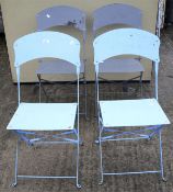 A set of four folding garden chairs.