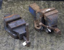 Two cast metal work bench vices.
