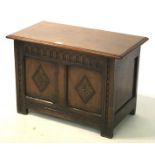 A small dark oak carved coffer in the 18th century style.