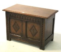 A small dark oak carved coffer in the 18th century style.