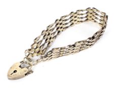 A silver-gilt four-spiral-bar gate-link bracelet.