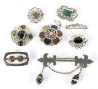 A collection of Scottish silver and white metal brooches.
