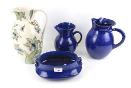 A Buchan jug and pieces of blue glazed ceramics.