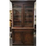 A Victorian mahogany glazed bookcase cupboard.