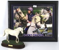 A Royal Doulton model of Desert Orchid on stand together with a framed photograph.
