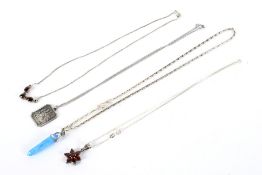 Four contemporary silver necklaces and pendants.