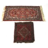 A Persian style floor rug and a child's prayer mat.