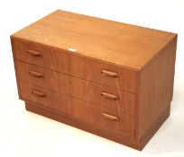 A retro teak chest of three long drawers. On a plinth base, L81.5cm x D46cm x H53.