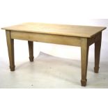 A light oak rectangular kitchen table on fluted tapering legs With cutlery drawer at one end.