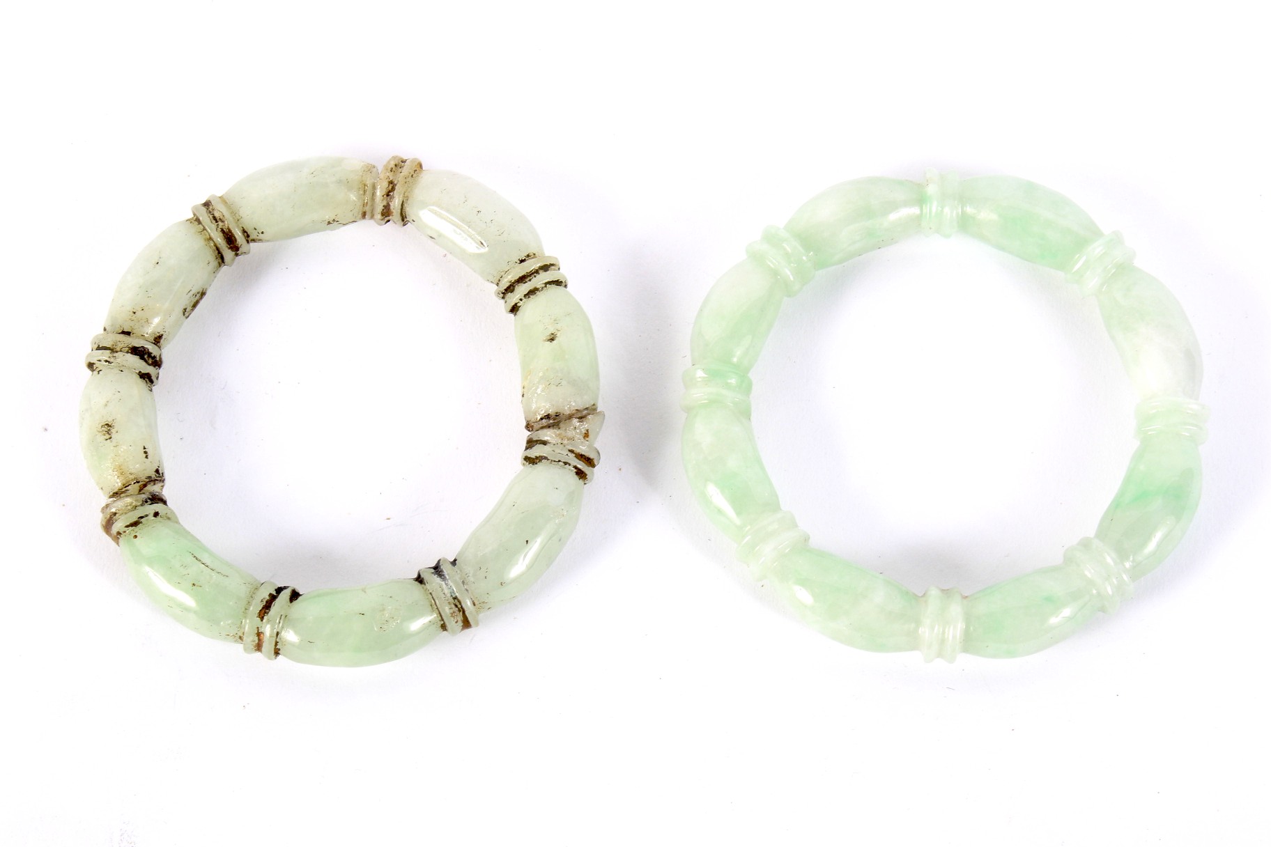 Two Chinese pale green hardstone bangles.