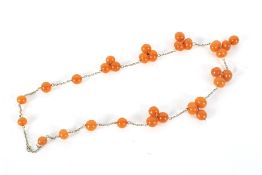 A gilt metal and imitation-amber bead necklace.