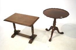 A contemporary mahogany effect pie crust tripod table.