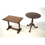A contemporary mahogany effect pie crust tripod table.