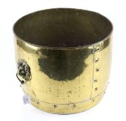 A large brass log bin. With lion head ring handle.