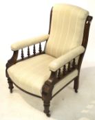 An Edwardian upholstered elbow chair.