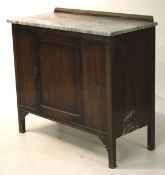 An Edwardian marble top wash stand cupboard.