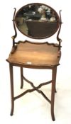 An Edwardian mahogany inlaid occasional table and a Regency mahogany oval dressing table mirror.