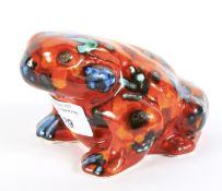 An Anita Harris signed ceramic figure of a frog. Glazed in orange and blue,