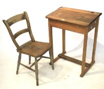 A child's vintage pine desk with rising lid and a chair.