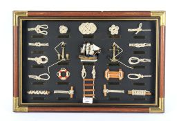 A framed set of ships knots and miniature parts.