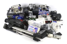An assortment of digital camera equipment, video cameras and accessories.