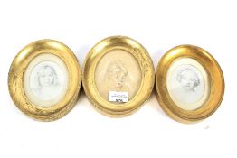 Three oval gilt framed portraits of girls, two in silk.