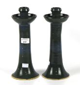 A pair of Pat Moore studio pottery candlesticks, signed Larry Moore '03.