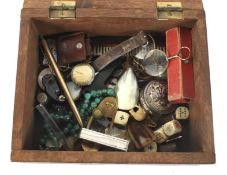 A mahogany box containing an assortment of collectables.
