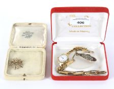 A vintage ladies rolled gold watch, a bracelet and two brooches.