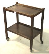 An early 20th century oak trolley. With two tiers, on wheels, L64.5cm x D41.5cm x H76.