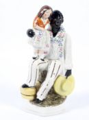 A 19th century Staffordshire pottery figure group of Uncle Tom and Eva.