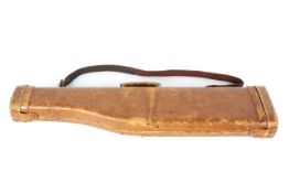 A vintage 20th century tan leather shotgun case with shoulder strap.