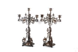 A pair of Victorian Gothic Revival iron and copper candelabra, circa 1880.