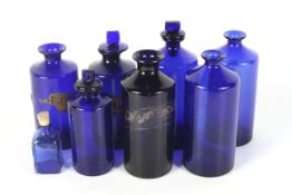 An assortment of 19th century Bristol blue apothecary bottles in various sizes.