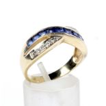 A modern tanzanite and diamond two-row cross-over ring.