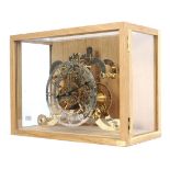 A mid-20th century Strutt epicyclic reproduction skeleton clock.