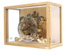 A mid-20th century Strutt epicyclic reproduction skeleton clock.