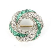 An early 20th century gold emerald and diamond spiral brooch/pendant.