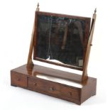 A Georgian mahogany swing mirror with three drawer base.