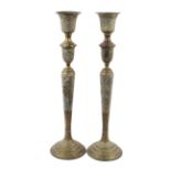 A pair of brass Islamic candle stands.