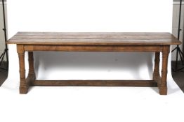 An early 19th century elm, triple plank top refectory dining table.