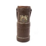 A WWI period cork shell case. Printed with the Royal Arms, with a brown leather strap handle,