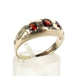 A vintage 9ct gold and garnet three stone gypsy ring.