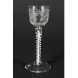 A late 18th century engraved opaque twist wine-glass.