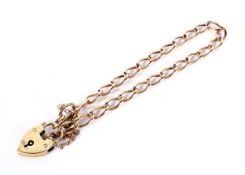 A rose gold curb bracelet on a 9ct yellow gold padlock clasp.