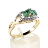 A modern 9ct gold, emerald and diamond dress ring.