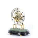 A small glass domed covered brass skeleton clock.