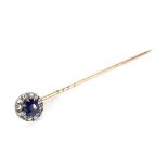 An early 20th century sapphire and diamond cluster stick pin.