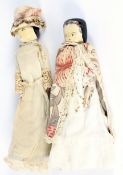 Two 19th century German pegged painted wooden dolls.