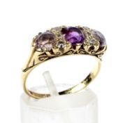 A vintage 18ct gold, amethyst and smoky-quartz three stone carved half-hoop ring